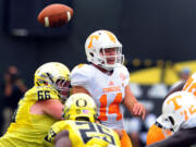 Tennessee quarterback Justin Worley (14) loses the ball as he is hit by Oregon defensive tackle Taylor Hart (66) during the second quarter Saturday in Eugene, Ore.