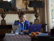 In this Thursday, Nov. 29, 2012 photo, National Public Radio host and journalist Michelle Norris works on a computer in her home in Washington where she is archiving her Race Card Project. The cards have become almost a parallel career for Norris. She and an assistant have catalogued more than 12,000 submissions online. People now send them via Facebook and Twitter or type them directly into the website, leading to vibrant online discussions.