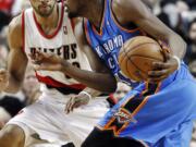 Oklahoma City Thunder forward Kevin Durant, right, drives on Portland Trail Blazers forward Nicolas Batum during the second half Sunday.