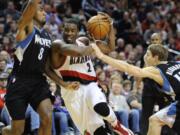 Portland Trail Blazers' Wesley Matthews (2) drives against Minnesota Timberwolves' Malcolm Lee (8) and Luke Ridnour during the second half Friday.