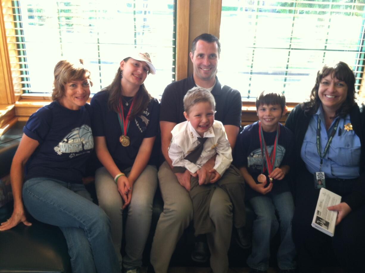 Pictured are Mindy Rothenberger, far right, &quot;Sheriff&quot; Carter Harris and his father, Dennison Harris, and Special Olympians and parents.