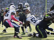 Seattle Seahawks Marshawn Lynch (24) breaks a tackle by outside linebacker Zach Brown (55) to run for a touchdown against the Tennessee Titans in the first half of an NFL football game, Sunday, Oct. 13, 2013, in Seattle.