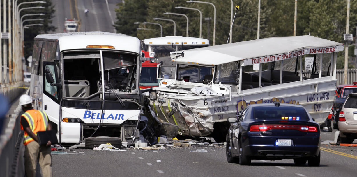 A &quot;Ride the Ducks&quot; amphibious tour bus, right, and a charter bus were involved in a fatal collision Sept. 24 on the Aurora Bridge in Seattle.