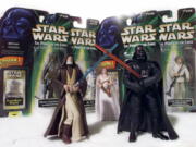 &quot;Star Wars&quot; action figures Darth Vader, right, and Ben (Obi-Wan) Kenobi, left, are displayed in 1999, with Princess Leia Organa in her ceremonial dress, in front of other packaged characters from the film series.