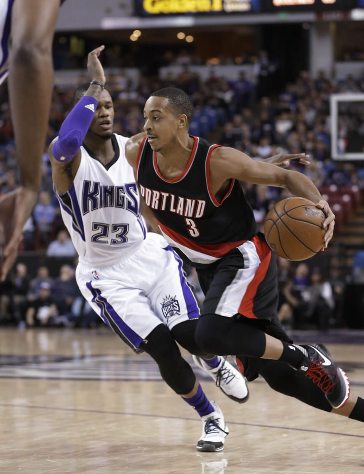 Portland Trail Blazers guard C.J. McCollum,, right, drives against Sacramento Kings guard Ben McLemore during the first quarter of an NBA basketball game in Sacramento, Calif., Sunday, Dec. 27, 2015.