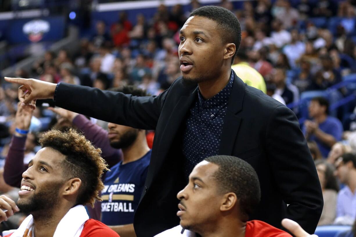 Injured Portland Trail Blazers guard Damian Lillard gestures from the bench during the first half of the team&#039;s NBA basketball game against the New Orleans Pelicans Wednesday, Dec. 23, 2015, in New Orleans. The Pelicans won 115-89.