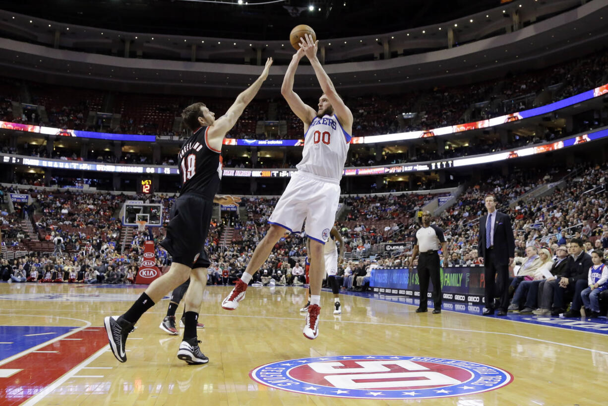 Philadelphia 76ers' Spencer Hawes (00) shoots against Portland Trail Blazers' Joel Freeland during the second half Monday.