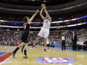 Philadelphia 76ers' Spencer Hawes (00) shoots against Portland Trail Blazers' Joel Freeland during the second half Monday.