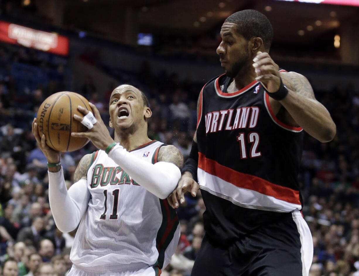 Milwaukee Bucks' Monta Ellis (11) drives past Portland Trail Blazers' LaMarcus Aldridge during the second half of an NBA basketball game Tuesday, March 19, 2013, in Milwaukee. The Bucks won 102-95.