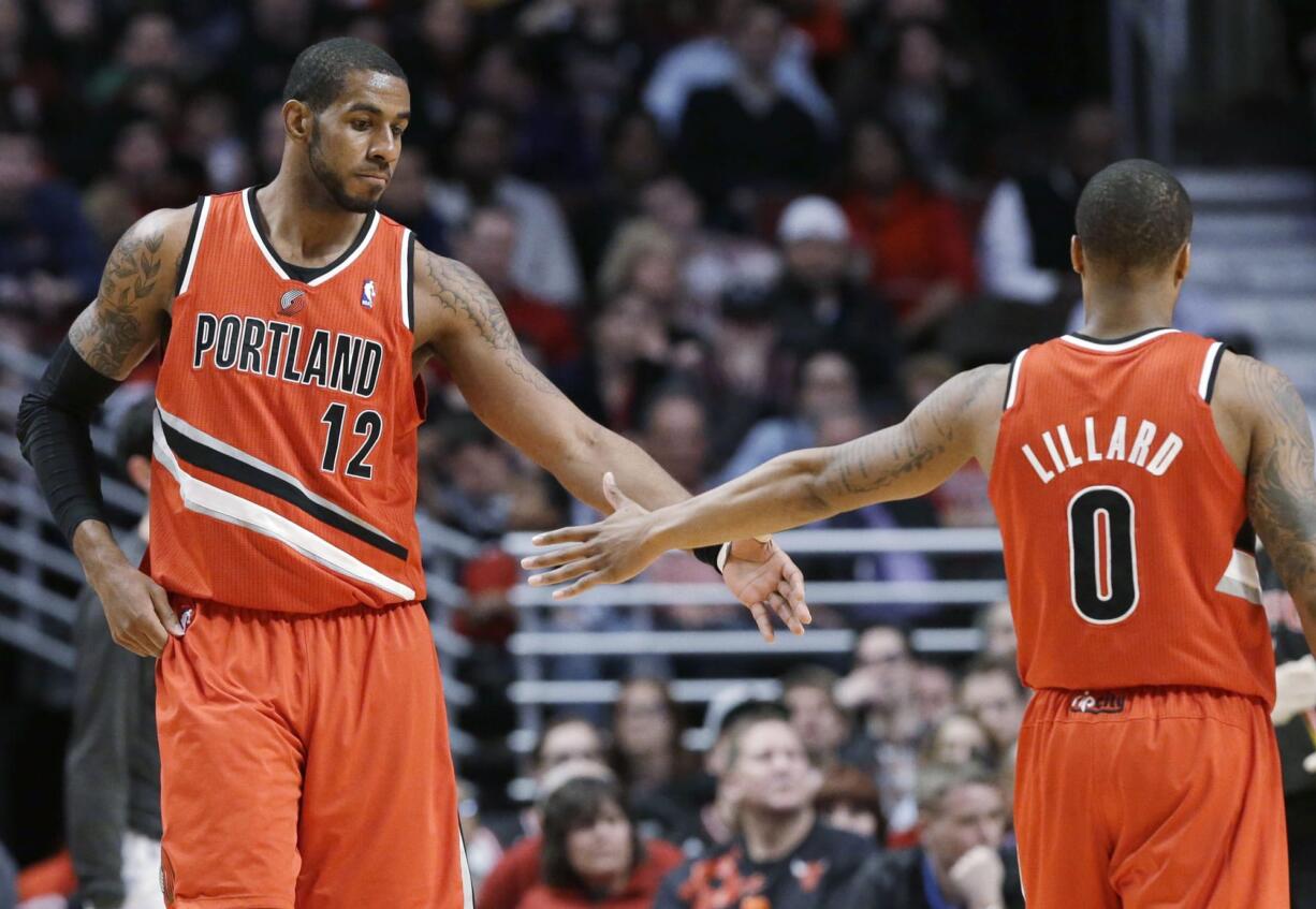 Portland Trail Blazers forward LaMarcus Aldridge, left, celebrates with guard Damian Lillard after scoring a basket during the second half Thursday.