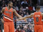 Portland Trail Blazers forward LaMarcus Aldridge, left, celebrates with guard Damian Lillard after scoring a basket during the second half Thursday.