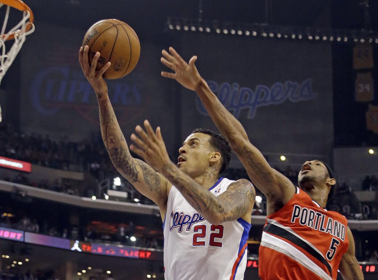 Reed Saxon/The Associated Press
Los Angeles Clippers forward Matt Barnes (22) shoots as Portland Trail Blazers guard Will Barton (5) defends in the first half of the Clippers' win.