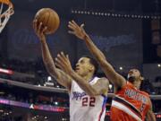 Reed Saxon/The Associated Press
Los Angeles Clippers forward Matt Barnes (22) shoots as Portland Trail Blazers guard Will Barton (5) defends in the first half of the Clippers' win.