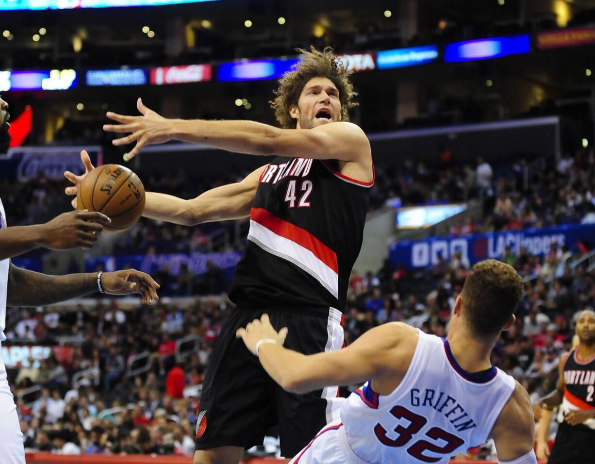 Portland Trail Blazers center Robin Lopez  collides with Los Angeles Clippers forward Blake Griffin in the first half Friday in Los Angeles.