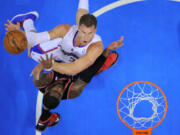 Los Angeles Clippers forward Blake Griffin, top, puts up a shot as Portland Trail Blazers forward LaMarcus Aldridge defends during the first half Sunday.