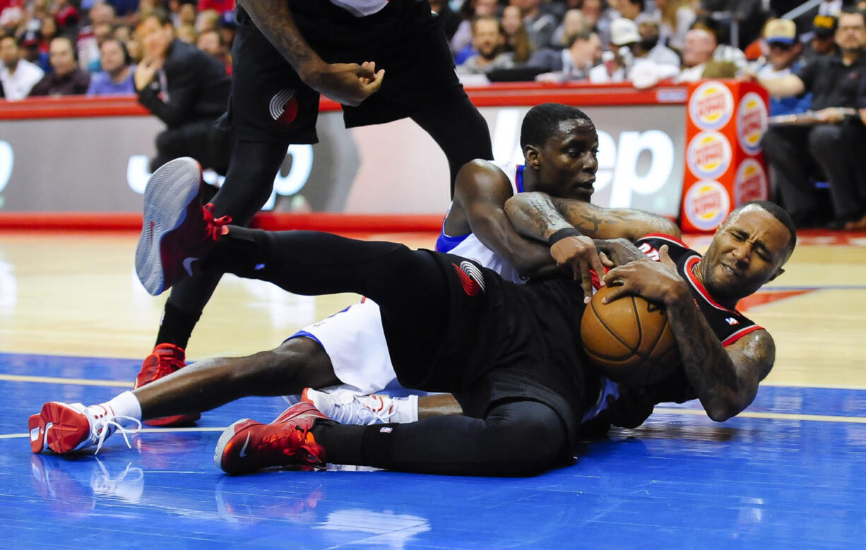 Portland Trail Blazers guard Mo Williams, front right, fights for a loose ball with Los Angeles Clippers guard Darren Collison during a preseason game Oct. 18.