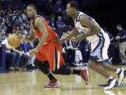 Portland Trail Blazers' Wesley Matthews (2) moves the ball past Memphis Grizzlies' Tony Allen, right, during the first half of an NBA basketball game in Memphis, Tenn., Friday, Jan. 4, 2013.