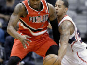 Atlanta Hawks' Devin Harris, right, guards Portland's Wesley Matthews.