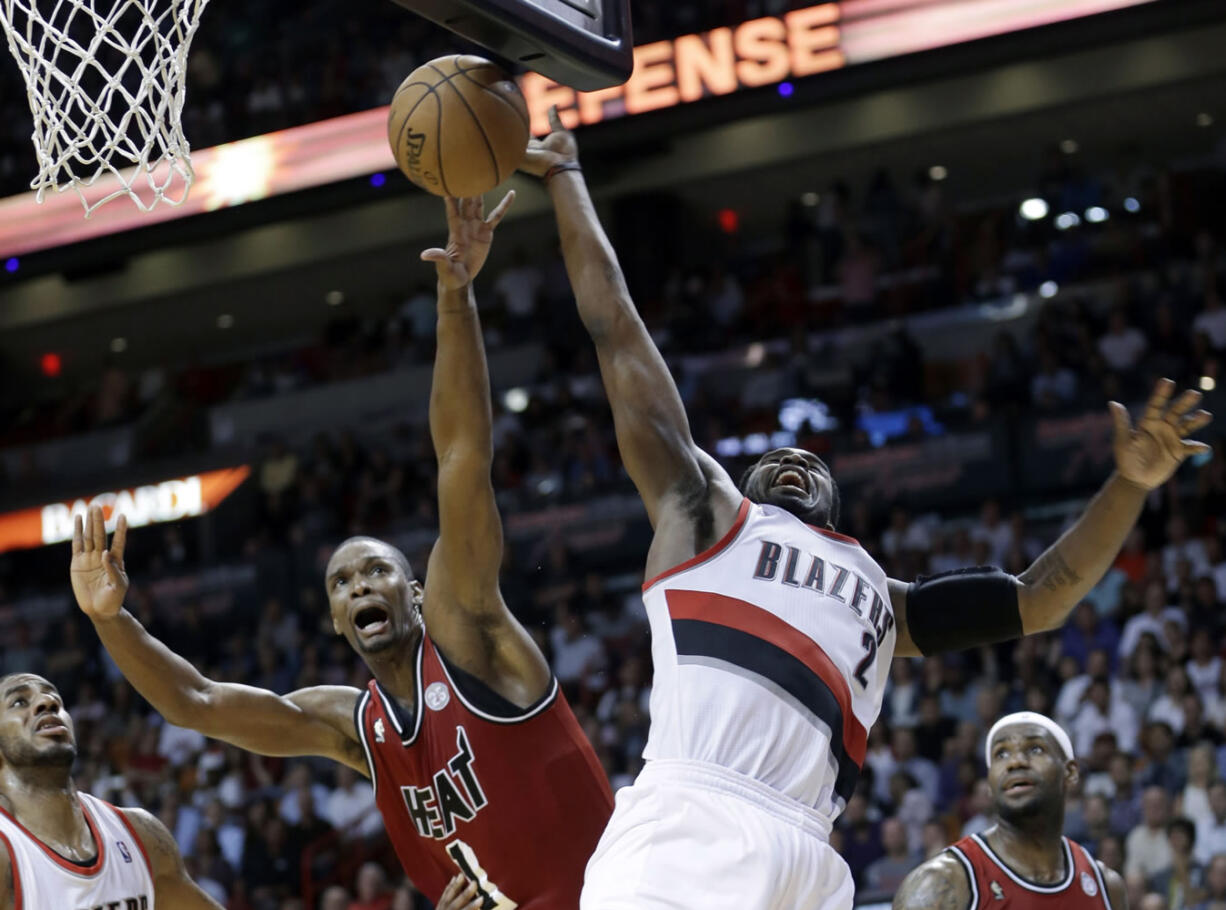 Miami Heat's Chris Bosh (1) blocks a shot by Portland Trail Blazers' Wesley Matthews (2) during the second half of an NBA basketball game in Miami, Tuesday, Feb. 12, 2013. The Heat won 117-104.