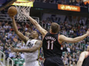 Utah's Derrick Favors (15) goes to the basket as Portland's Meyers Leonard (11) defends in the fourth quarter  Monday at Salt Lake City.