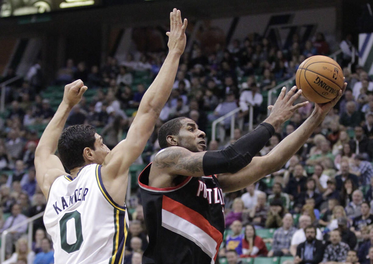 Portland Trail Blazers forward LaMarcus Aldridge (12) drives to the basket as Utah Jazz center Enes Kanter (0) defends during the second quarter in a preseason game Thursday.