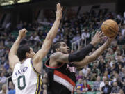 Portland Trail Blazers forward LaMarcus Aldridge (12) drives to the basket as Utah Jazz center Enes Kanter (0) defends during the second quarter in a preseason game Thursday.