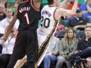 Portland Trail Blazers' Dorell Wright (1) defends Utah Jazz's Gordon Hayward (20) in a preseason game Oct.