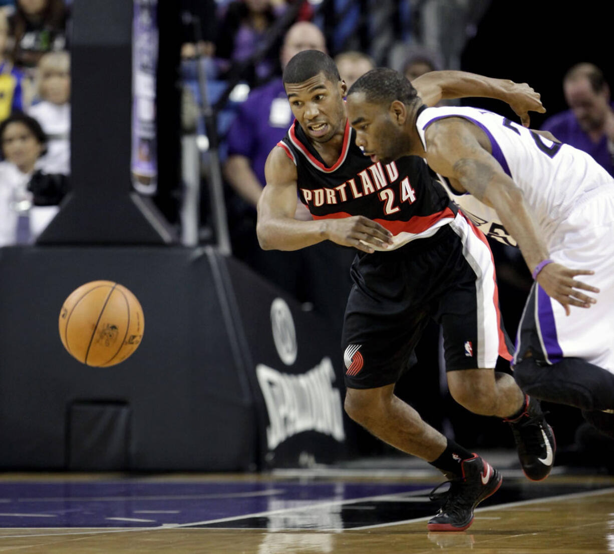 Portland Trail Blazers guard Ronnie Price, left, and Sacramento Kings guard  Marcus Thornton chase down a loose ball  during the first half of an NBA basketball game in Sacramento, Calif., Tuesday, Nov. 13, 2012.