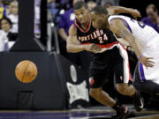 Portland Trail Blazers guard Ronnie Price, left, and Sacramento Kings guard  Marcus Thornton chase down a loose ball  during the first half of an NBA basketball game in Sacramento, Calif., Tuesday, Nov. 13, 2012.