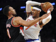 New York Knicks' Carmelo Anthony, right, is pressured by Portland Trail Blazers' Jared Jeffries during the second quarter Tuesday.