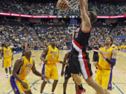 Portland Trail Blazers center Meyers Leonard slam dunks over Los Angeles Lakers during Wednesday's preseason game at Ontario, Calif.