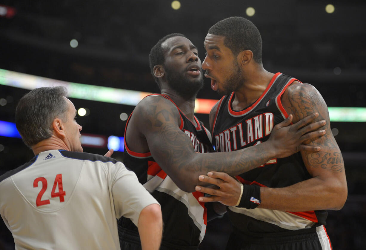 Portland Trail Blazers forward LaMarcus Aldridge, right, yells at referee Mike Callahan as center J.J. Hickson holds him back during the second half of their NBA basketball game against the Los Angeles Lakers, Friday, Feb. 22, 2013, in Los Angeles. Aldridge received a technical foul right after. The Lakers won 111-107. (AP Photo/Mark J.