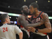 Portland Trail Blazers forward LaMarcus Aldridge, right, yells at referee Mike Callahan as center J.J. Hickson holds him back during the second half of their NBA basketball game against the Los Angeles Lakers, Friday, Feb. 22, 2013, in Los Angeles. Aldridge received a technical foul right after. The Lakers won 111-107. (AP Photo/Mark J.