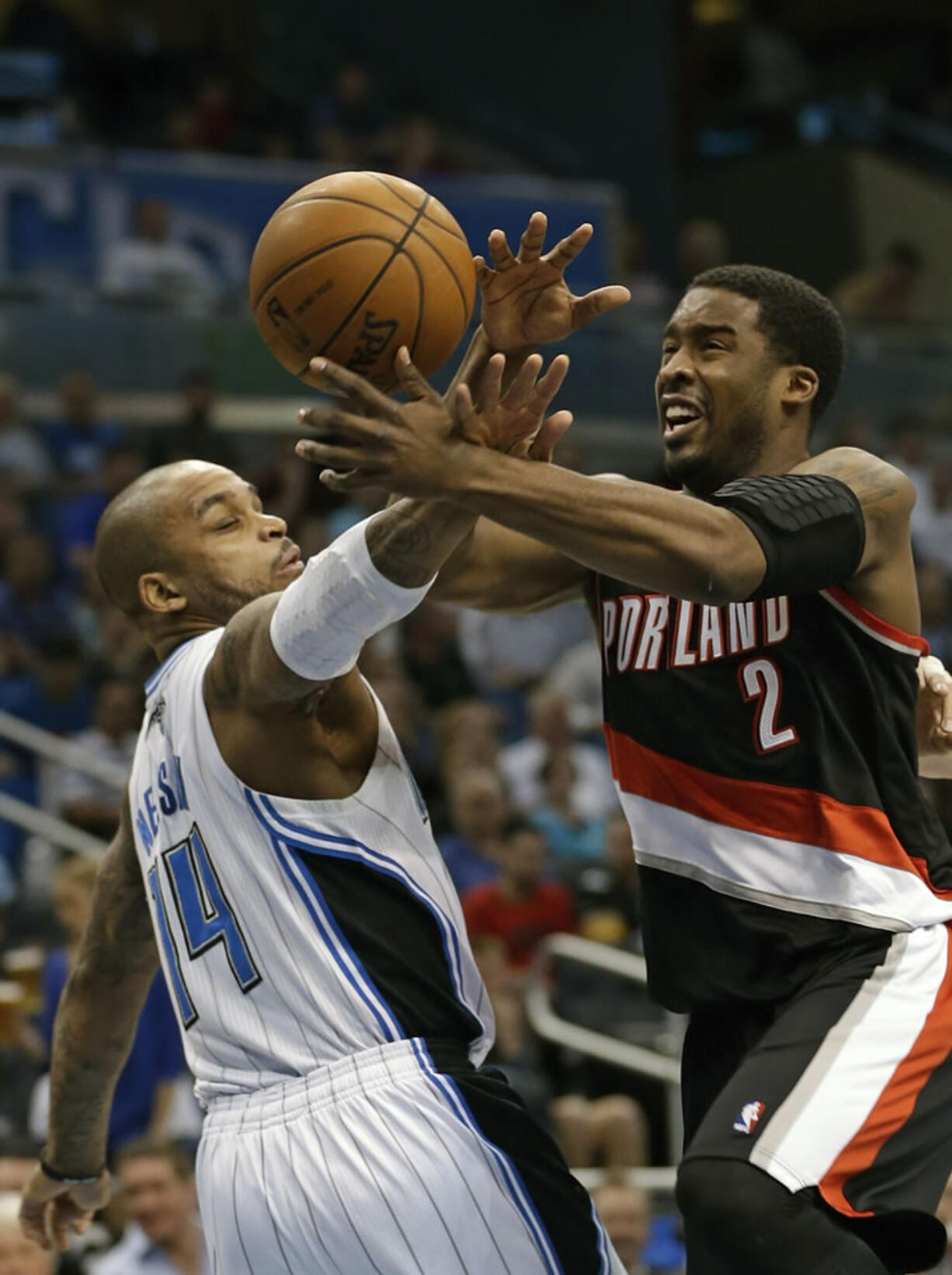 Portland Trail Blazers' Wesley Matthews (2) is fouled by Orlando Magic's Jameer Nelson (14) as he drives to the basket during the first half Sunday.