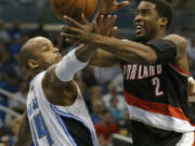 Portland Trail Blazers' Wesley Matthews (2) is fouled by Orlando Magic's Jameer Nelson (14) as he drives to the basket during the first half Sunday.