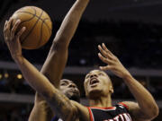 Dallas Mavericks' Elton Brand (42) defends against a shot by Portland Trail Blazers' Damian Lillard (0) in the first half Wednesday.