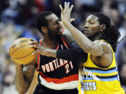 Denver Nuggets forward Kenneth Faried pressures Portland Trail Blazers center J.J.