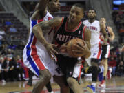 Portland Trail Blazers guard Damian Lillard (0) drives on Detroit Pistons guard Brandon Knight (7) during the first quarter Monday.