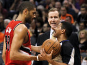 Portland Trail Blazers' Nicolas Batum, left, and head coach Terry Stotts, both argue with referee Bill Kennedy, right, after Batum was called for a foul during the first half Wednesday in Phoenix.