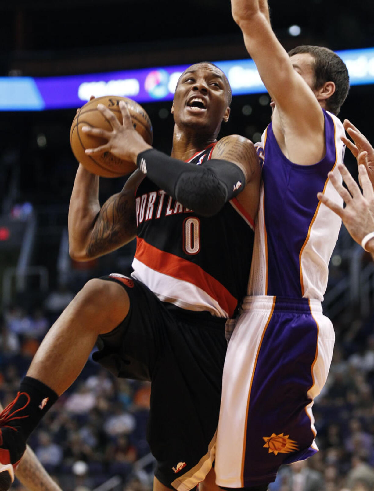 Portland Trail Blazers' Damian Lillard (0) drives past Phoenix Suns' Goran Dragic during the first half of Friday's preseason game at Phoenix.