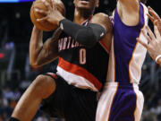 Portland Trail Blazers' Damian Lillard (0) drives past Phoenix Suns' Goran Dragic during the first half of Friday's preseason game at Phoenix.