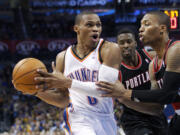 Oklahoma City Thunder guard Russell Westbrook (0) drives past Portland Trail Blazers guard Damian Lillard, right, during the fourth quarter Friday.