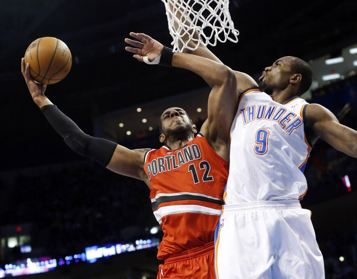 Portland's LaMarcus Aldridge (12) is fouled by Oklahoma City's Serge Ibaka (9) during the first quarter Sunday.