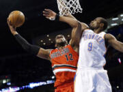 Portland's LaMarcus Aldridge (12) is fouled by Oklahoma City's Serge Ibaka (9) during the first quarter Sunday.