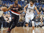 Portland Trail Blazers' Wesley Matthews (2) moves the ball alongside Minnesota Timberwolves' Ricky Rubio (9), of Spain, during the fourth quarter of an NBA basketball game Monday, Feb. 4, 2013, in Minneapolis. The Trail Blazers won 100-98.