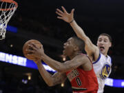 Portland Trail Blazers' Damian Lilliard (0) shoots past Golden State Warriors' Klay Thompson during the second half of an NBA basketball game Friday, Jan. 11, 2013, in Oakland, Calif.