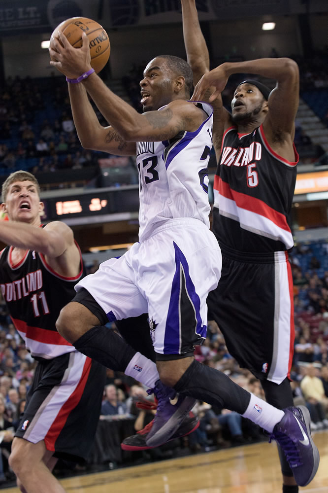 Sacramento Kings' guard Marcus Thornton (23) drives to the basket past Portland Trail Blazers' defenders, Meyers Leonard (11) and Will Barton (5) during Sunday's game.