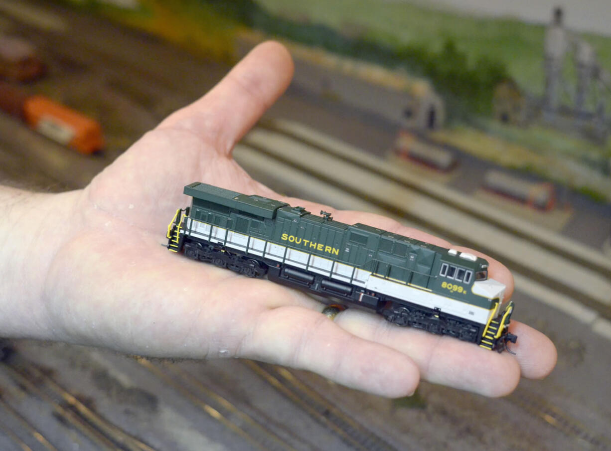 In this Saturday, Dec. 5, 2015, photo, Steve McCartt holds one of his N scale train engines during an open house at the Whatcom Skagit Model Railroad Club&#039;s headquarters in Alger, Wash.