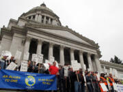 Supporters of a transportation revenue package hold a rally on the Capitol steps on Monday in Olympia. Lawmakers are in the midst of a 30-day special legislative session to address the main state operating budget, but Gov.