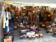 A cluttered storefront in the Kichijoji neighborhood of Tokyo. The neighborhood is home to small shops and Inokashira Park, with a pond and zoo.